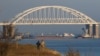 A Russian cargo ship is seen beneath a bridge connecting the Russian mainland with the Crimean Peninsula after three Ukrainian navy vessels were stopped by Russia from entering the Sea of Azov via the Kerch Strait in the Black Sea, Crimea November 25, 201